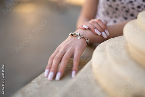 close-up of a girl's hand with a beautiful manicure and a jewelry bracelet on her hand