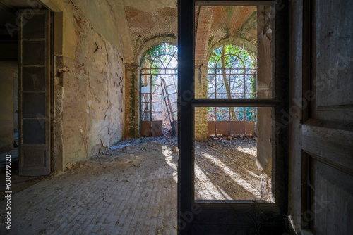 porch with broken glass in an abandoned mansion