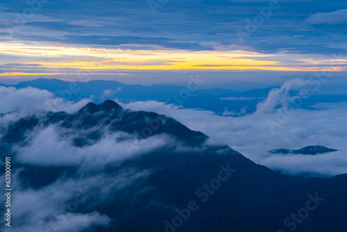 Mountain peak and sunrise covered by the sea of cloud in northern of thailand (Nan province, Thailand) เด่นช้างนอน © Puwaphat