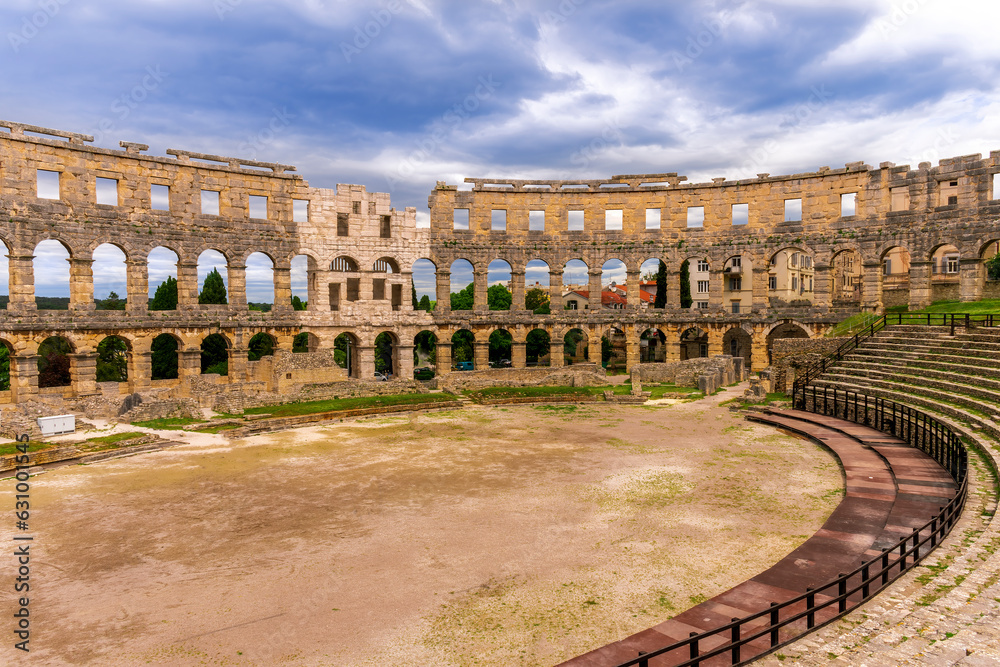 ancient roman amphitheater in Pula, Croatia, great arena in colosseum style outdoor, landscape of historical building for tourism with blue cloudy sky on background