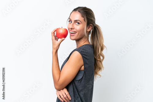 Young pretty Uruguayan woman isolated on white background eating an apple