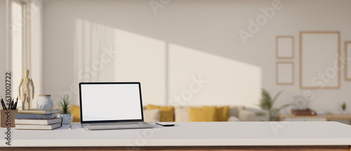 A laptop mockup is on a white tabletop with decor in a modern and cozy living room