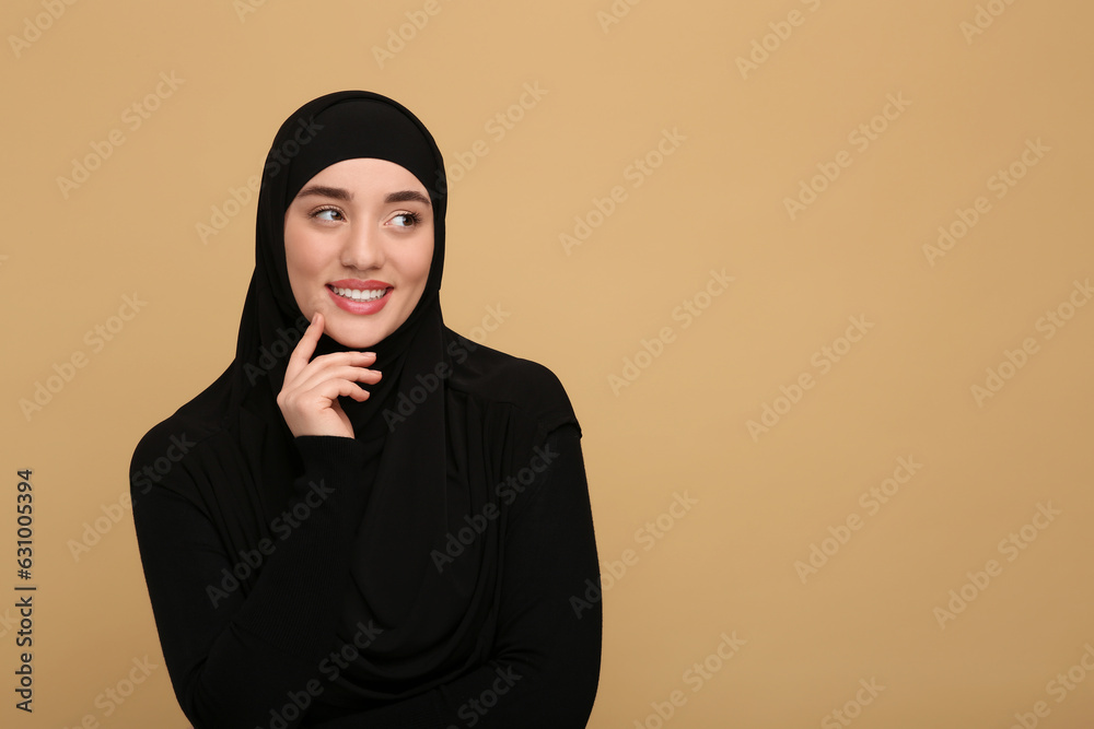 Portrait of Muslim woman in hijab on beige background, space for text Portrait of Muslim woman in hijab on beige background, space for text