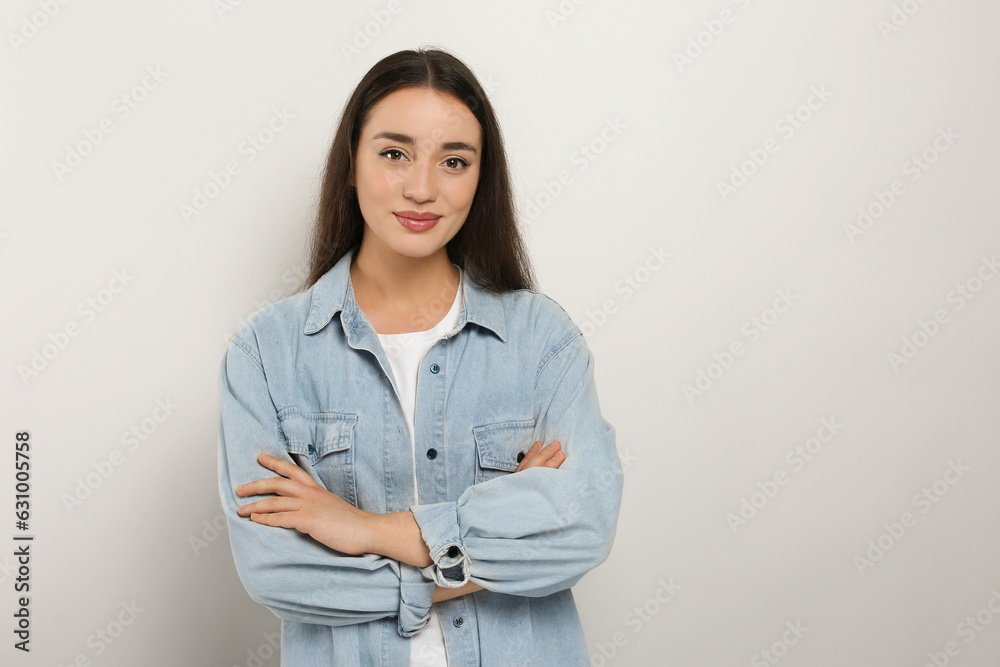 Portrait of beautiful young woman in jeans jacket on white background. Space for text Portrait of beautiful young woman in jeans jacket on white background. Space for text