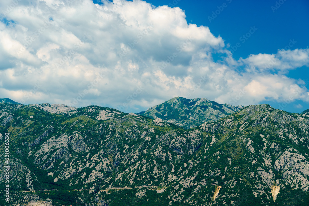 a top of mountains and cloudy sky in the Bay of Kotor during a cruise on a ship in Montenegro, a bright sunny day, mountains and coast, the concept of a summer trip