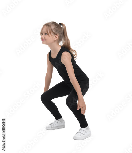 Little girl doing squats on white background. Morning exercise
