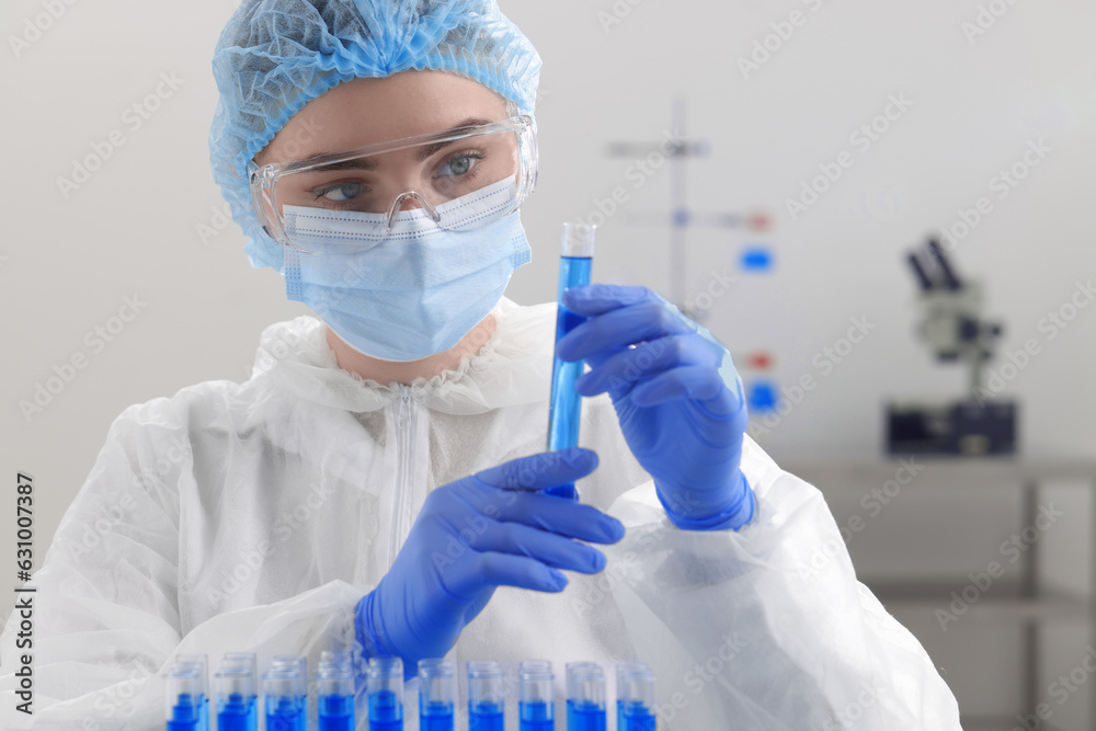 Scientist holding test tube with sample in laboratory Scientist holding test tube with sample in laboratory