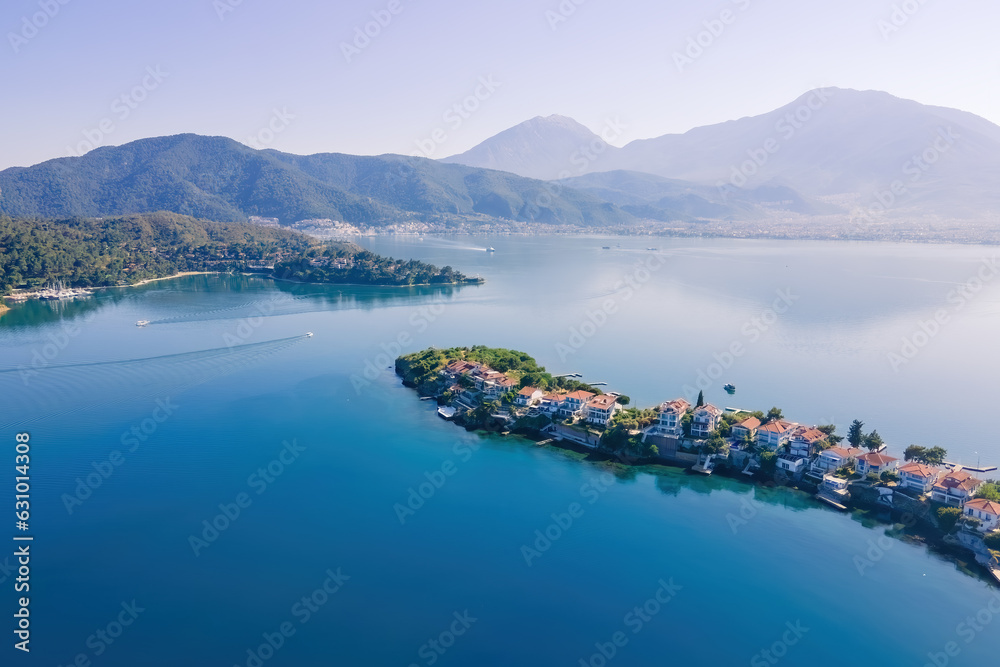 Beachfront villas on private island in Aegean sea for luxury holiday, Aerial view