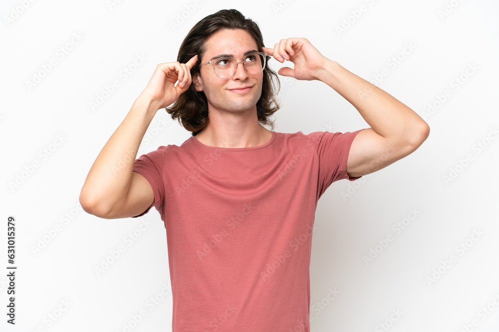 Young handsome man isolated on white background having doubts and thinking Young handsome man isolated on white background having doubts and thinking