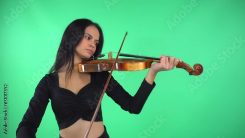 girl playing violin in green studio photo