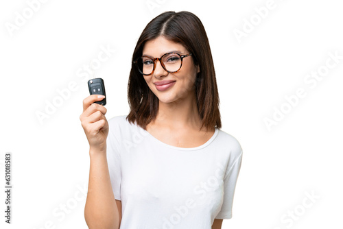 Fotografie Young Russian woman holding car keys over isolated chroma key background smiling