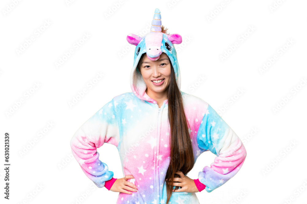 Young Asian woman with unicorn pajamas over isolated chroma key background posing with arms at hip and smiling Young Asian woman with unicorn pajamas over isolated chroma key background posing with arms at hip and smiling