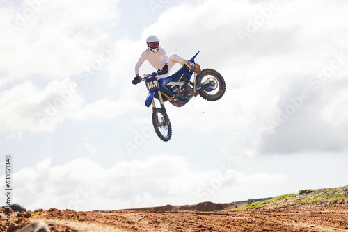 Sports, jump and man on motorcycle with freedom, energy and power stunt in the countryside for training challenge. Off road, air and male jumping with motorbike for speed, performance or Moto action