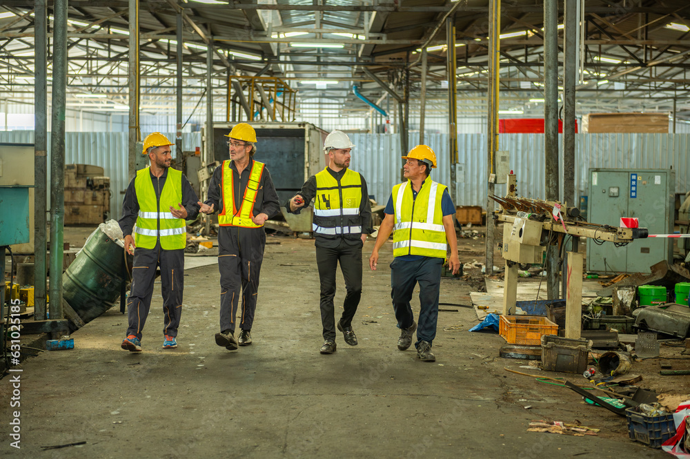Group of engineer foreman walk line of troops straight in and talk together at end time of work in old Factory. unity teamwork colleague foreman and trainee walk straight in and talk collaboration. Group of engineer foreman walk line of troops straight in and talk together at end time of work in old Factory. unity teamwork colleague foreman and trainee walk straight in and talk collaboration.