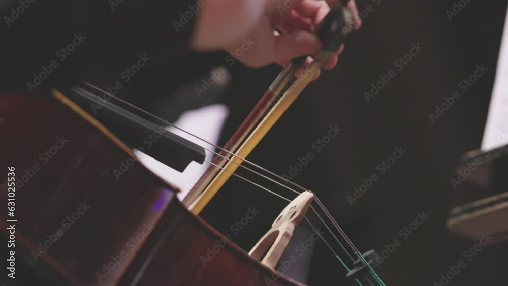 Slow motion video of a musician playing an acoustic cello with a bow during a performance. Nr.11 Slow motion video of a musician playing an acoustic cello with a bow during a performance. Nr.11