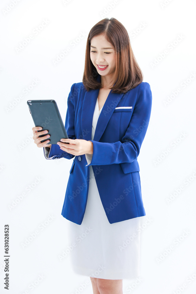 Isolated cutout studio shot Asian beautiful professional successful female businesswoman employee in formal business suit wear standing smiling using touchscreen tablet computer on white background Isolated cutout studio shot Asian beautiful professional successful female businesswoman employee in formal business suit wear standing smiling using touchscreen tablet computer on white background
