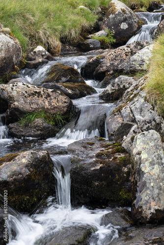 Above Llyn Ogwen.  Mountain stream with rocks and stones.  Slightly blurred water.