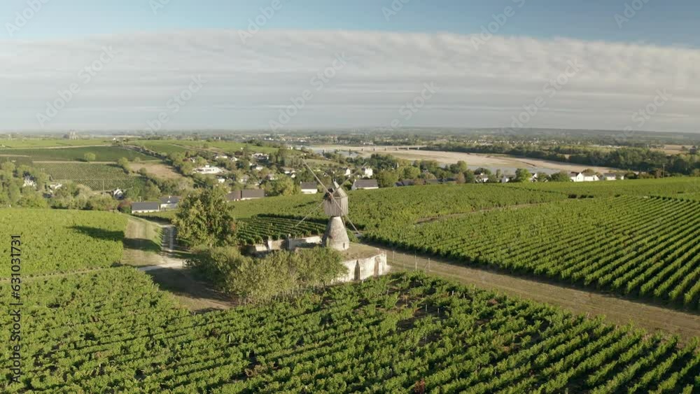 Aerial drone point of view of the 18th century windmill Moulin de la Tranchee near to Montsoreau in the UNESCO World Heritage Site Loire Valley, France. Aerial drone point of view of the 18th century windmill Moulin de la Tranchee near to Montsoreau in the UNESCO World Heritage Site Loire Valley, France.