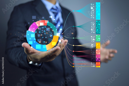 Businessman hand holding chart on big data technology. Scientist computing, analysing and visualizing complex data set on donut. Data mining, artificial intelligence, business science analytics.