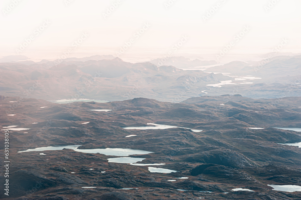 Mountains and lakes of Greenland in foggy morning.Aerial view