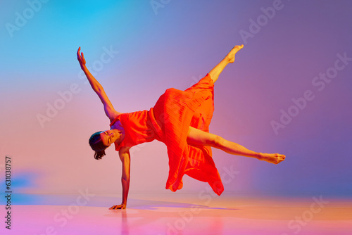 Classic and modern. Elegant young woman dancing contemp in dress against gradient multicolor background in neon light. Concept of modern dance style, hobby, art, performance, lifestyle, ad photo