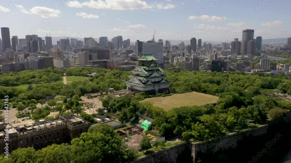Aerial of Osaka Castle with trees, park, moat, skyscraper, and city in Osaka, Japan. Aerial of Osaka Castle with trees, park, moat, skyscraper, and city in Osaka, Japan.