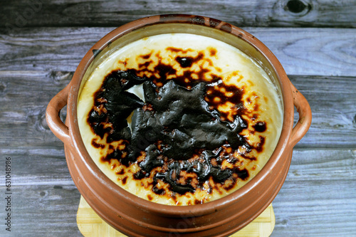 Rice pudding pottery casserole over baked burnt in the oven, rice, corn flour, sugar, water or milk and other ingredients such as cinnamon, vanilla, called Riz au lait, Sütlaç, Sholezard and moghli photo