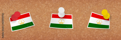 Tajikistan flag pinned in cork board, three versions of Tajikistan flag.