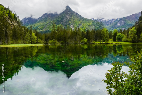 lake with wonderful reflections from the mountains and green hills