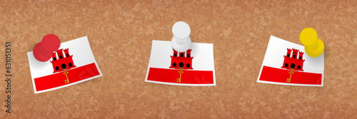Gibraltar flag pinned in cork board, three versions of Gibraltar flag.