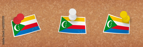 Comoros flag pinned in cork board, three versions of Comoros flag.