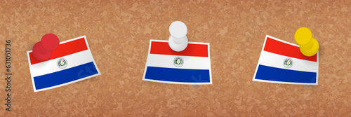 Paraguay flag pinned in cork board, three versions of Paraguay flag.