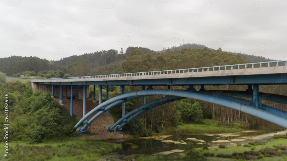 Cinematic rising aerial from below bridge, revealing Spanish highway. Cantabria Cinematic rising aerial from below bridge, revealing Spanish highway. Cantabria
