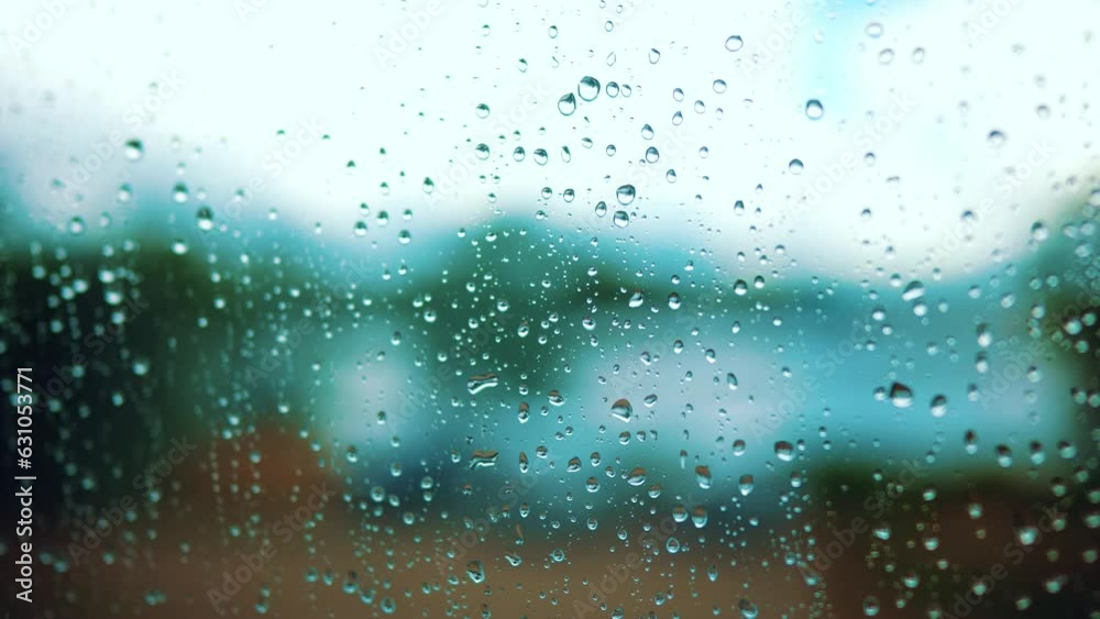 raindrop on the window in autumn a background. wet glass rain drops rainy sky blurred background close-up. rain in lifestyle the window on the background of the sky blurred plan