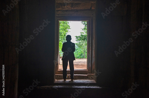 Silhouette man in entrance of ancient sandstone castle