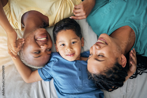 LGBT family, child and happy portrait on bed in home bedroom for security, quality time and love. Adoption, lesbian or gay women or parents with a foster kid for care or relax in morning from above