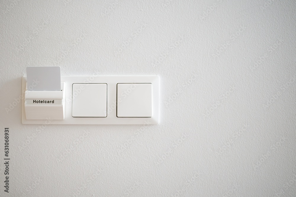 Hotelcard and switches on the background of a white wall. Hotelcard and switches on the background of a white wall.