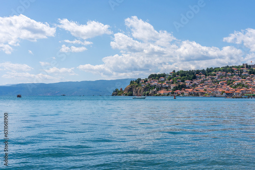 Lake Ohrid North Macedonia with the city built into the mountain in the background on a Summer day with blue sky and clouds