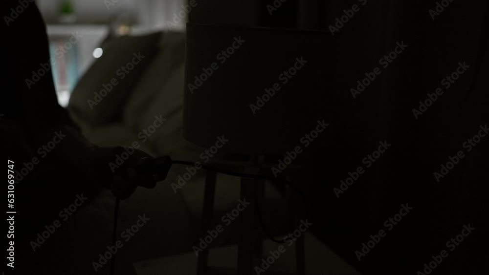 Young blonde woman sitting on bed turning lamp off at bedroom Young blonde woman sitting on bed turning lamp off at bedroom