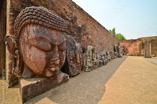 Tablou pe pânză Gaint stone head of Meditating Buddha hand carved in stone  along with other excavated remains on display inside  Ratnagiri Buddhist archaeological site complex, Jajpur, Odisha, India