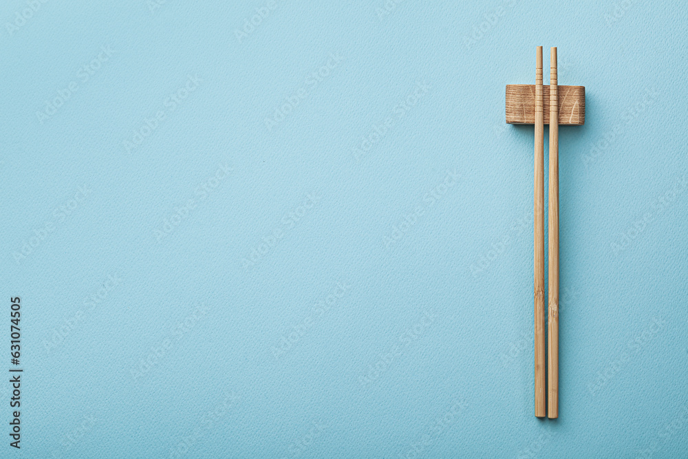 Freespace For Your Text Wooden Choppingsticks On Blue Background.