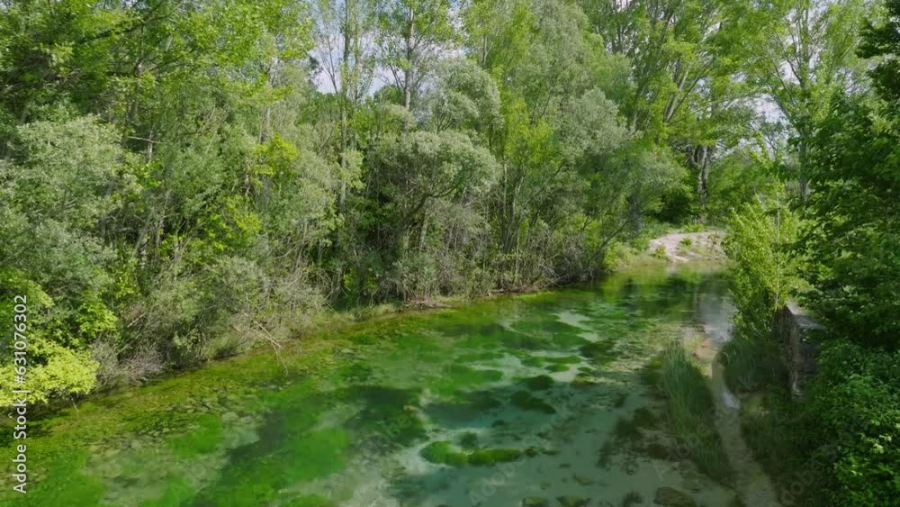 Aerial following forward the calm green river Cetina in Croatia on a sunny day Aerial following forward the calm green river Cetina in Croatia on a sunny day