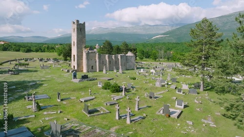Aerial of old church and cemetery by green nature in Cetina, Croatia photo
