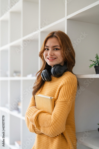 Young woman asian at home relaxing in her living room reading book