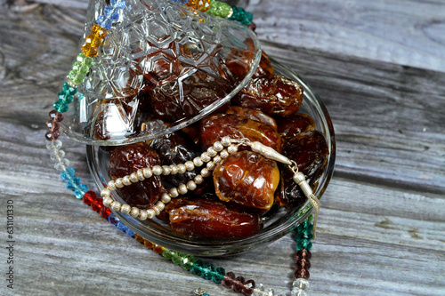 Ramadan background, Ajwa dates, a cultivar of the palm date that is widely grown in Medina, Saudi Arabia., an oval-shaped, medium-sized date, and Islamic crystal 99 beads and silver 33 beads rosaries photo