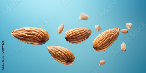 Closeup of almond nuts falling surrounded by almond crumbs isolated on flat blue background with copy space. 3d render illustration style. 