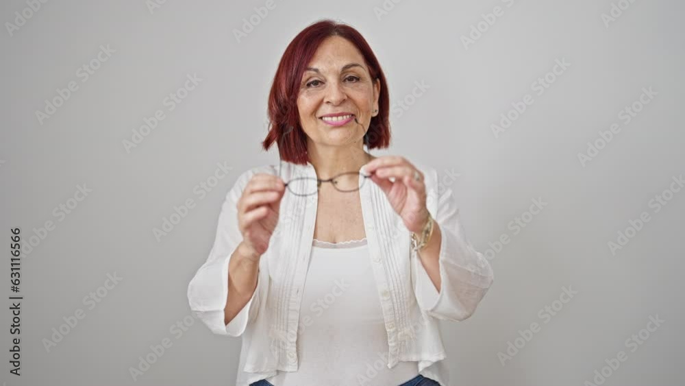 Middle age woman smiling confident taking glasses off over isolated white background Middle age woman smiling confident taking glasses off over isolated white background