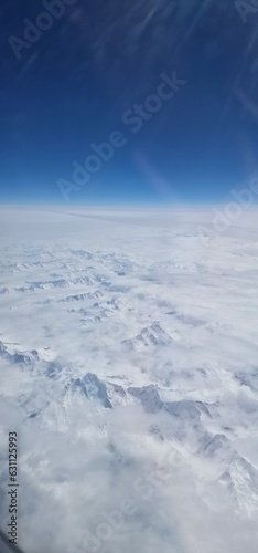 flight view over the snow-capped Alps is a breathtaking spectacle that unfolds like a majestic painting. As the plane soars above these towering peaks, the landscape transforms into a pristine winter 