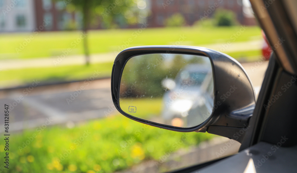 Car mirror reflects life's journeys, offering introspection and foresight. Symbolizes reflection, self-awareness and moving forward