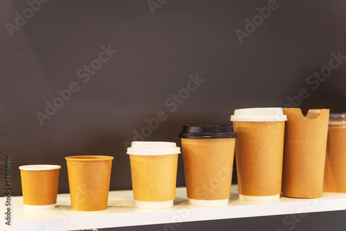 different disposable paper cups for coffee and tea. presentation of a variety of eco-friendly utensils for hot drinks. fast food cups photo